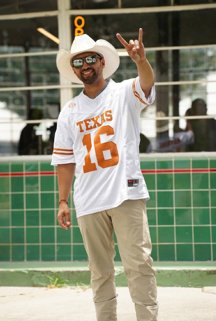 Person wearing a white Texas number 16 football jersey