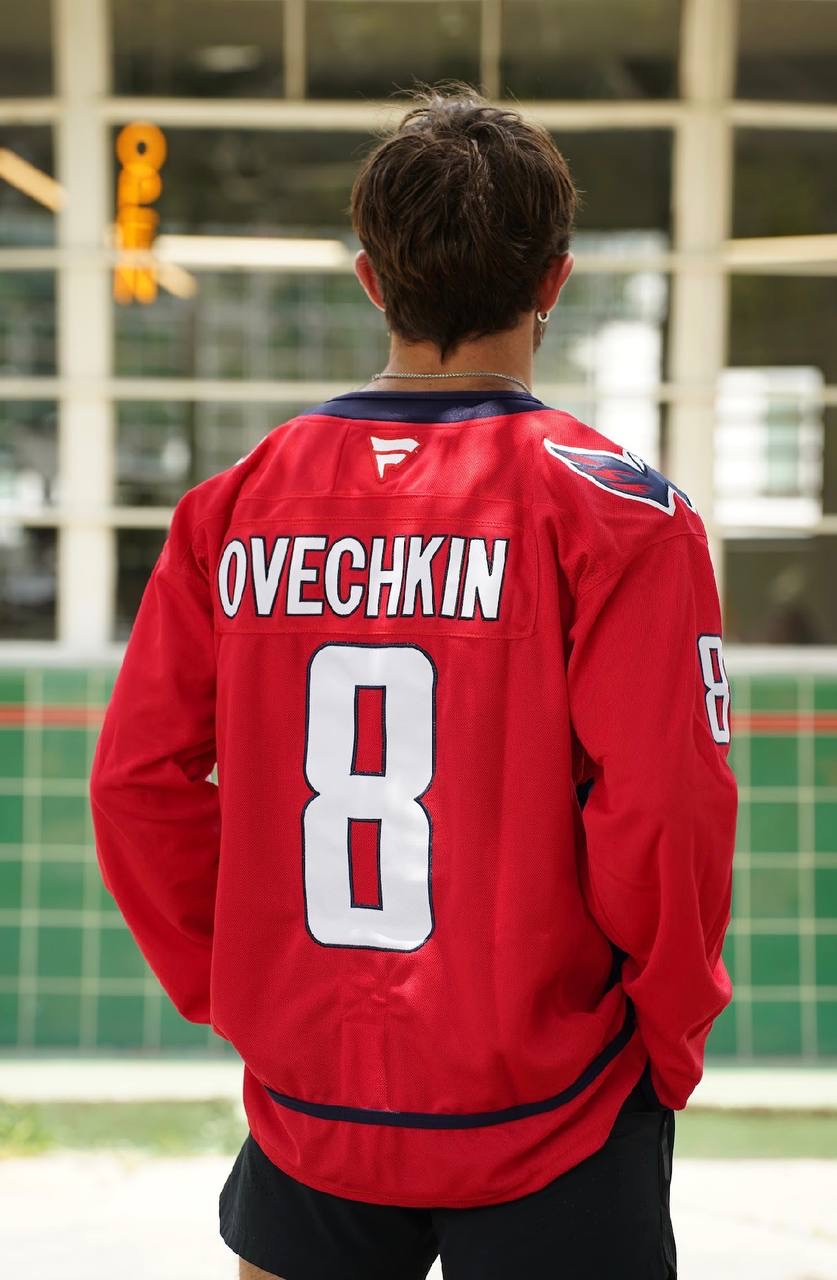 Back view of a red Ovechkin number 8 hockey jersey being worn