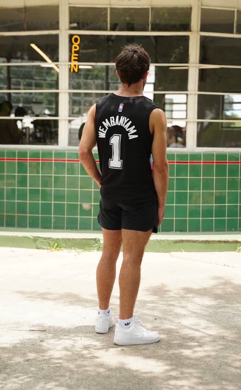 Back view of a black Wembanyama number 1 basketball jersey being worn